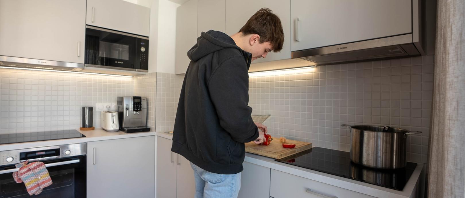 Student cooking in his apartment